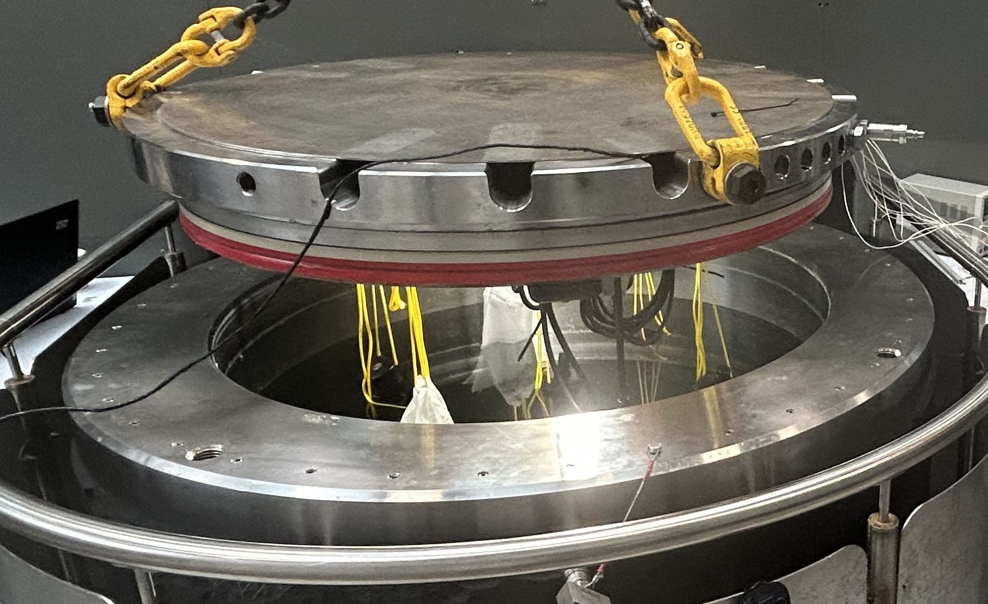 Figure 2 – Equipment being lowered into pressure test tank.